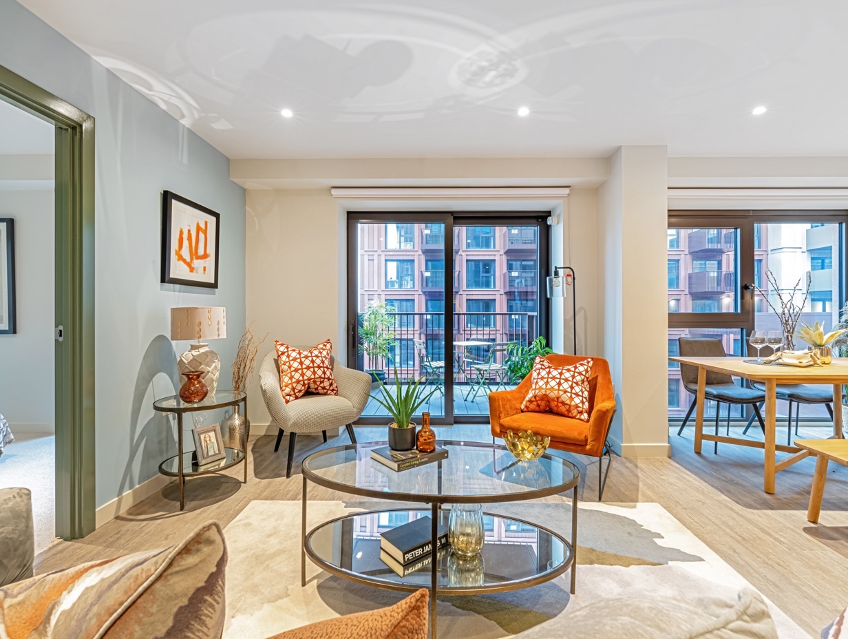 The living and dining room of a Zen flat, with doors open to the balcony